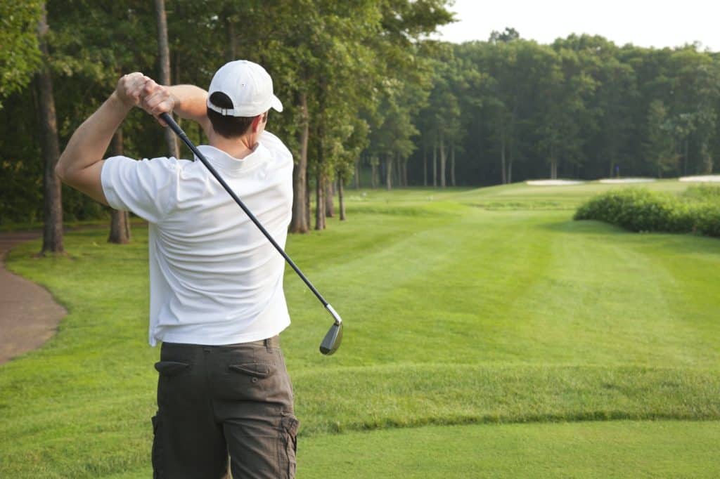 Golfer Tees Off on Golf Hole